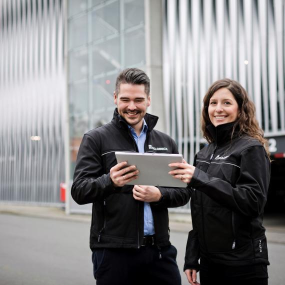 Employees in front of building